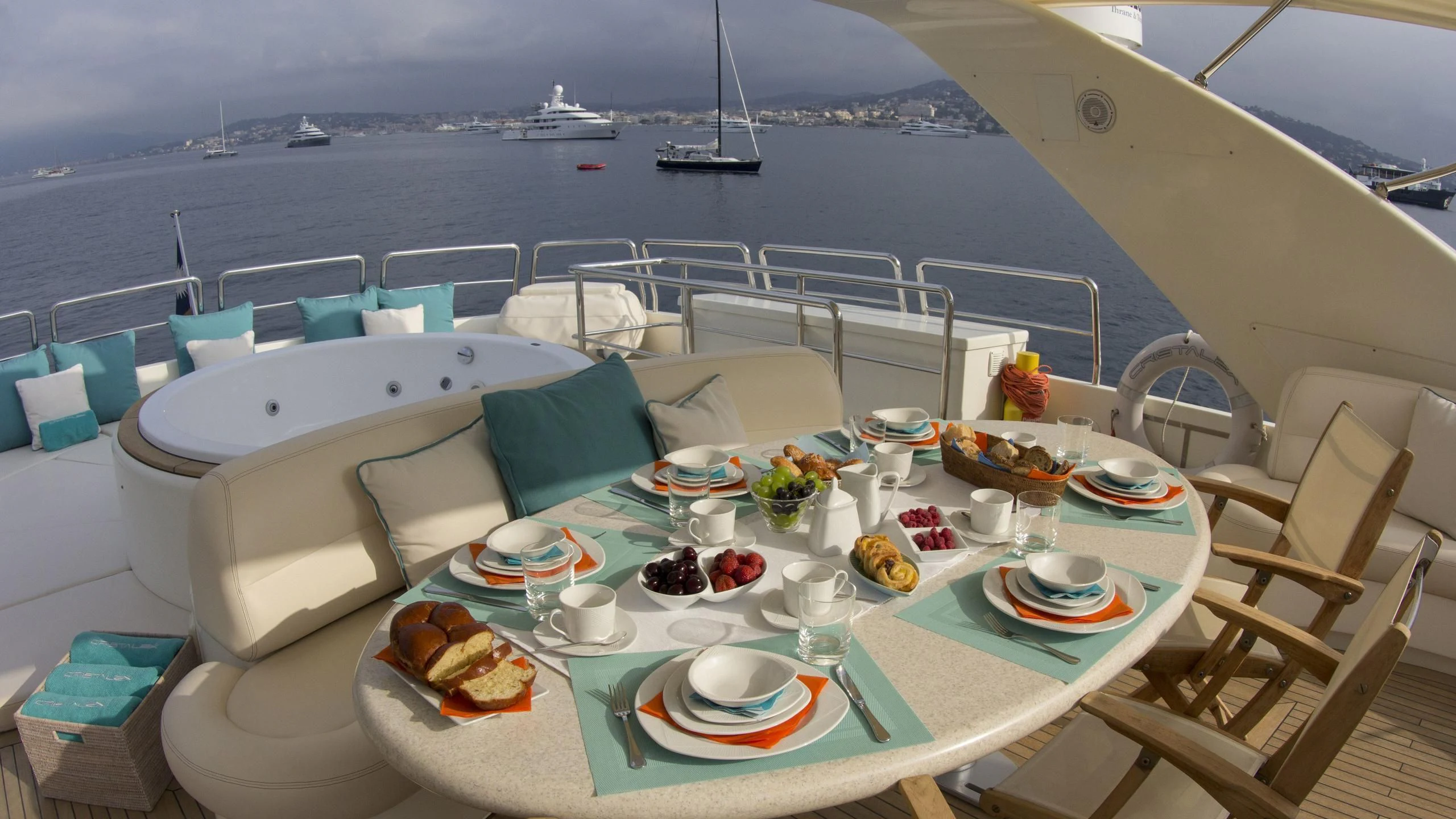 a table with plates and food on it aboard CRISTALES Yacht for Sale