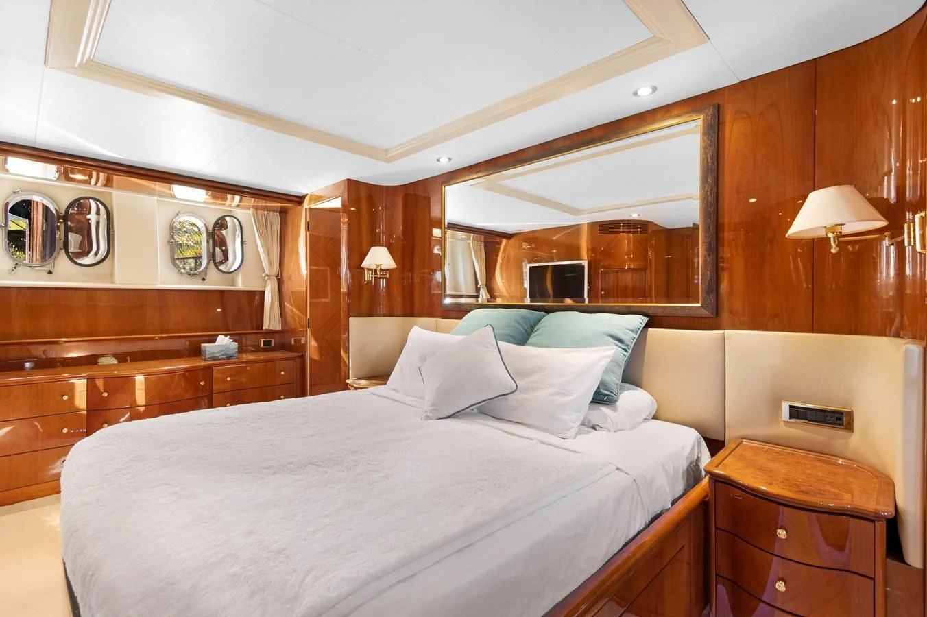 a bedroom with a bed and a dresser aboard CRISTALES Yacht for Sale