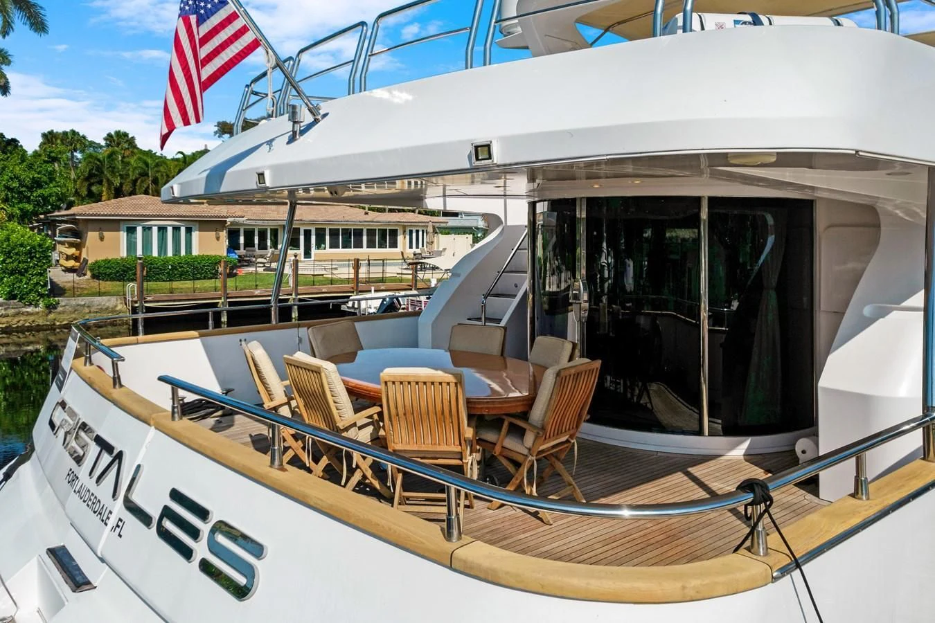 a boat with a flag on the deck aboard CRISTALES Yacht for Sale