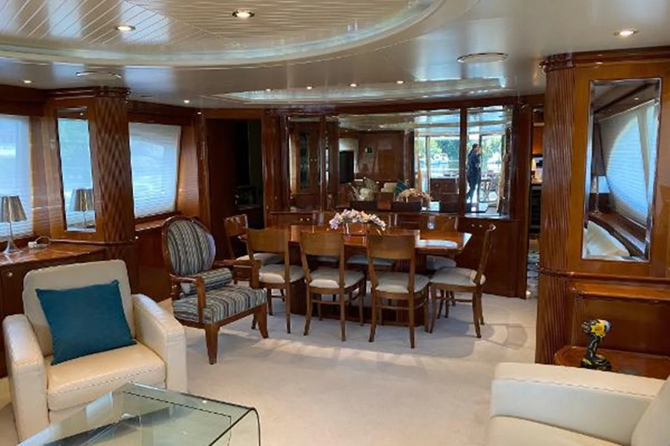 a room with a table chairs and a couch aboard CRISTALES Yacht for Sale