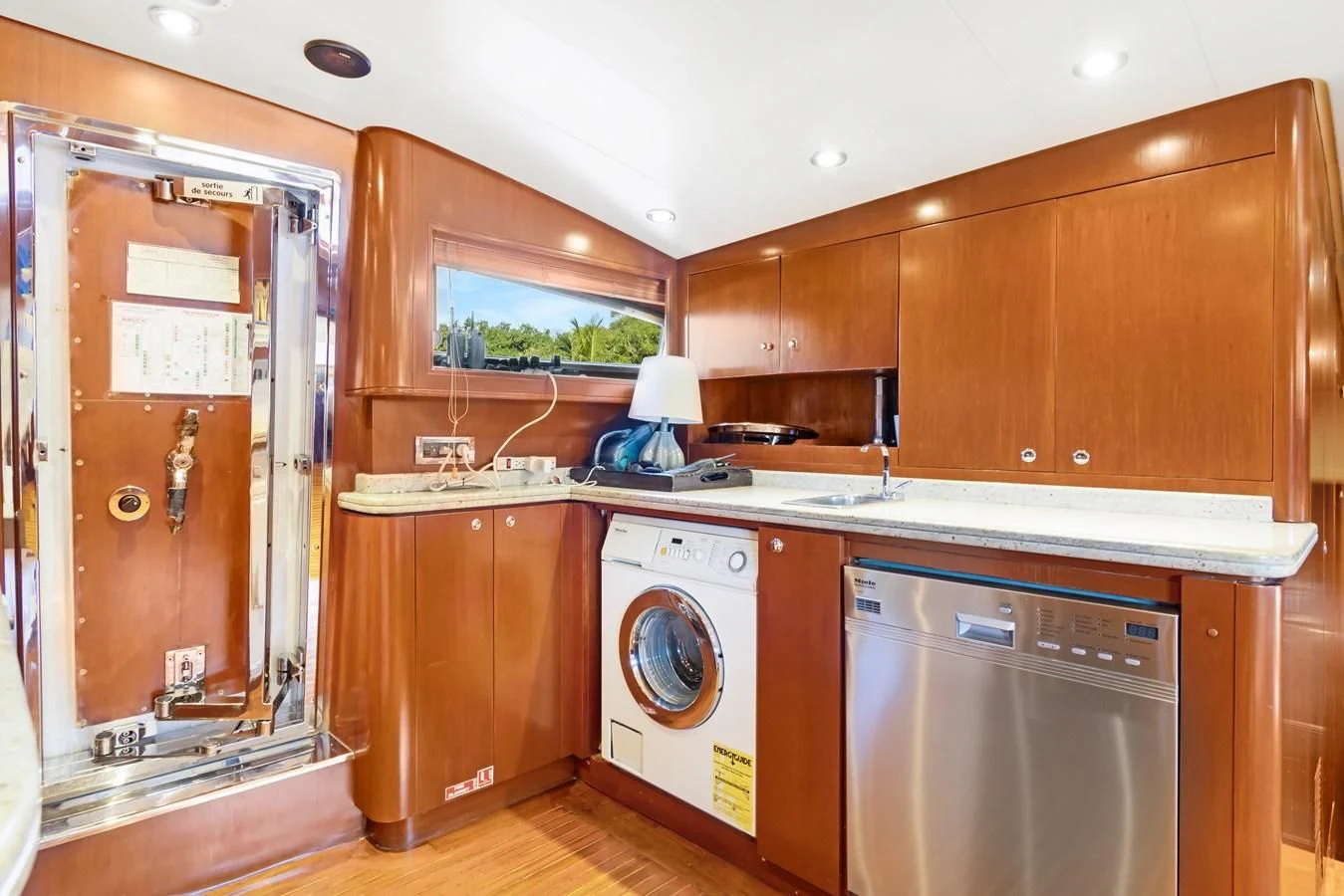 a kitchen with wooden cabinets aboard CRISTALES Yacht for Sale