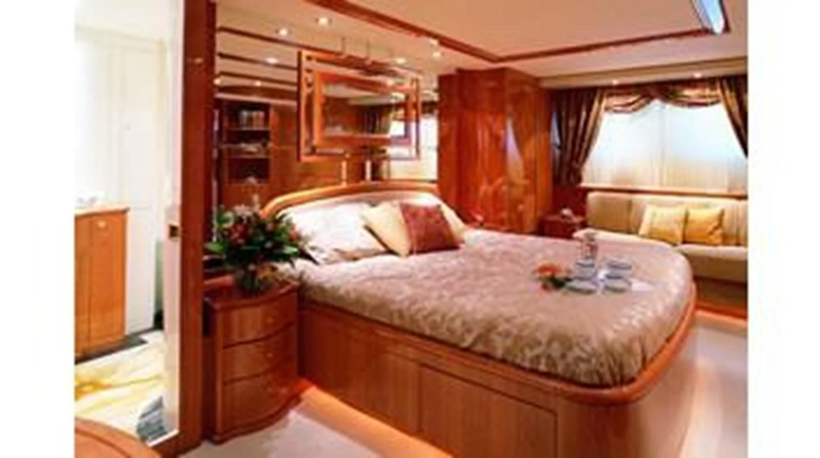 a bed with a flower on the side aboard CRISTALES Yacht for Sale