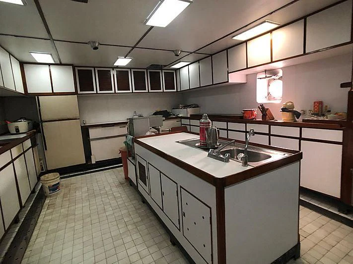 a kitchen with a large island aboard VAN TRIUMPH Yacht for Sale