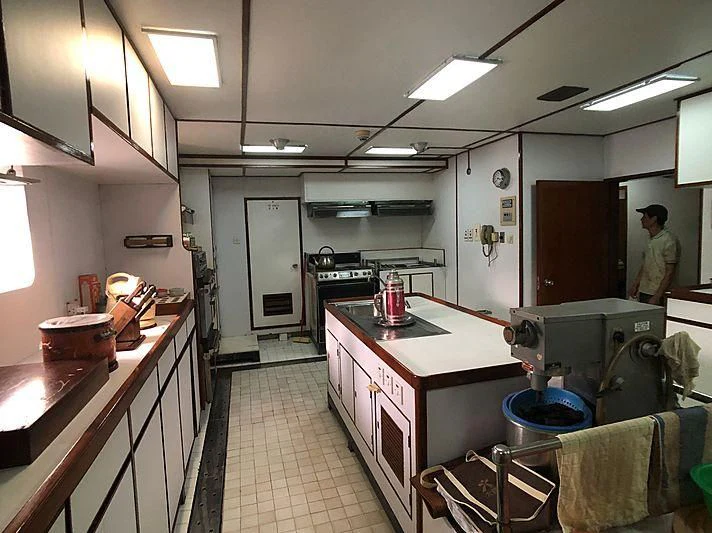 a kitchen with a stove and a sink aboard VAN TRIUMPH Yacht for Sale