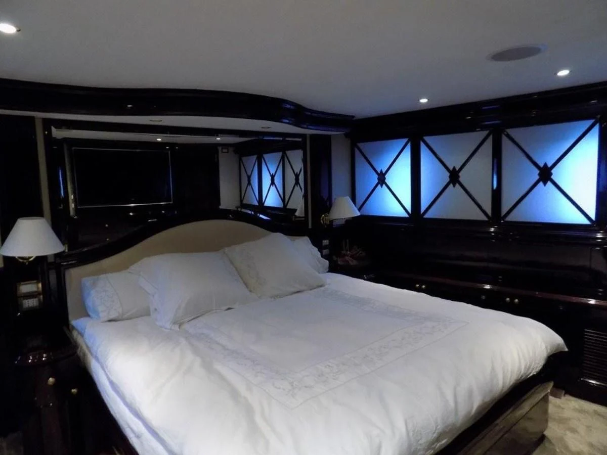 a bed with white sheets aboard BENDIS Yacht for Sale