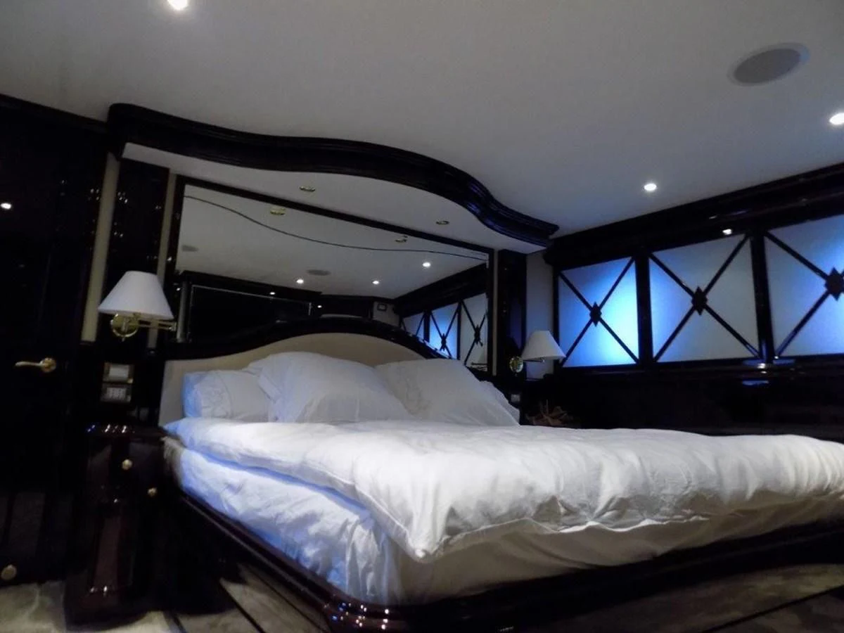 a bed with a white sheet aboard BENDIS Yacht for Sale