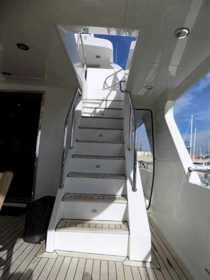 a white staircase with a glass door aboard BENDIS Yacht for Sale