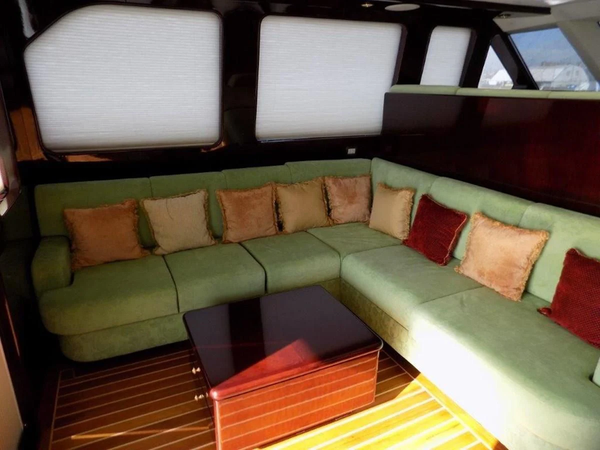 a couch with a table in the middle aboard BENDIS Yacht for Sale