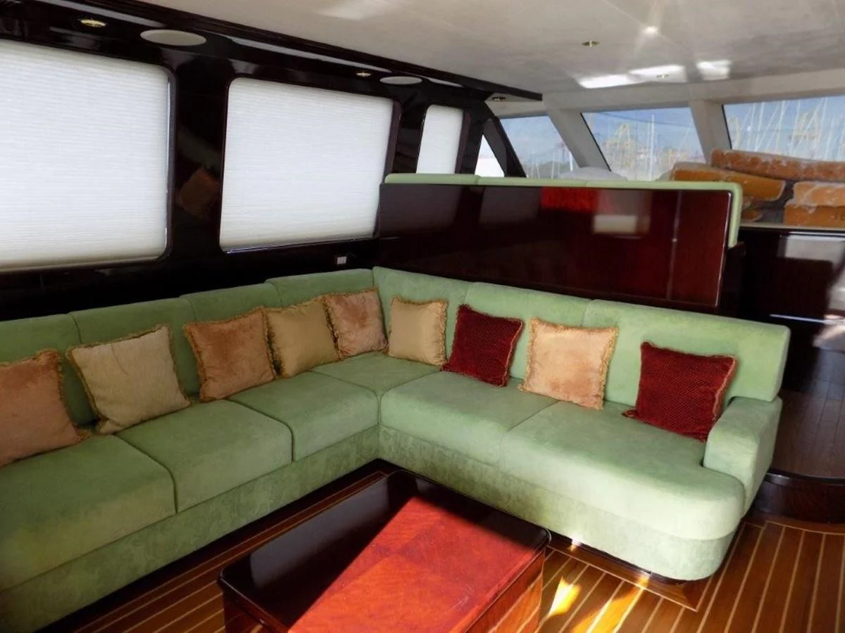 a couch with pillows on it aboard BENDIS Yacht for Sale