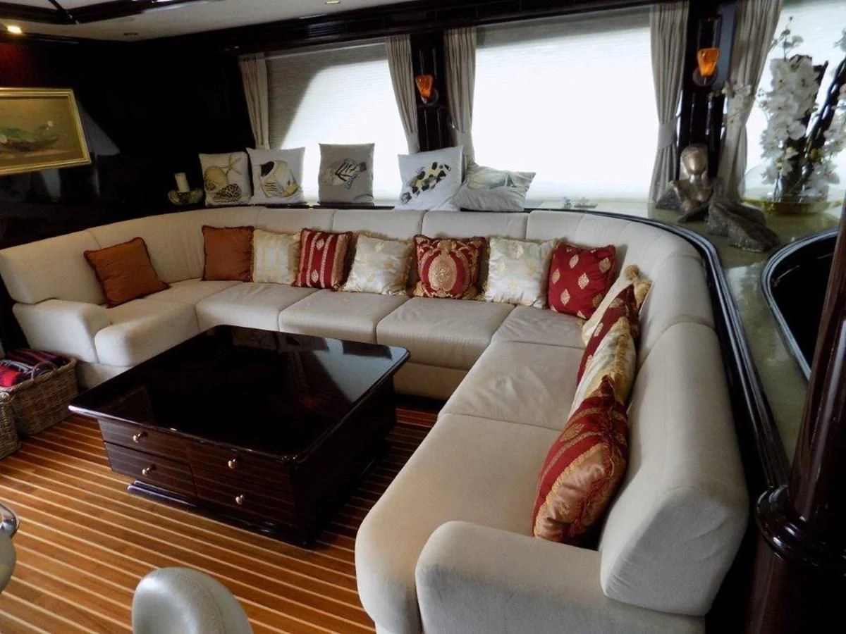 a living room with a couch and a coffee table aboard BENDIS Yacht for Sale
