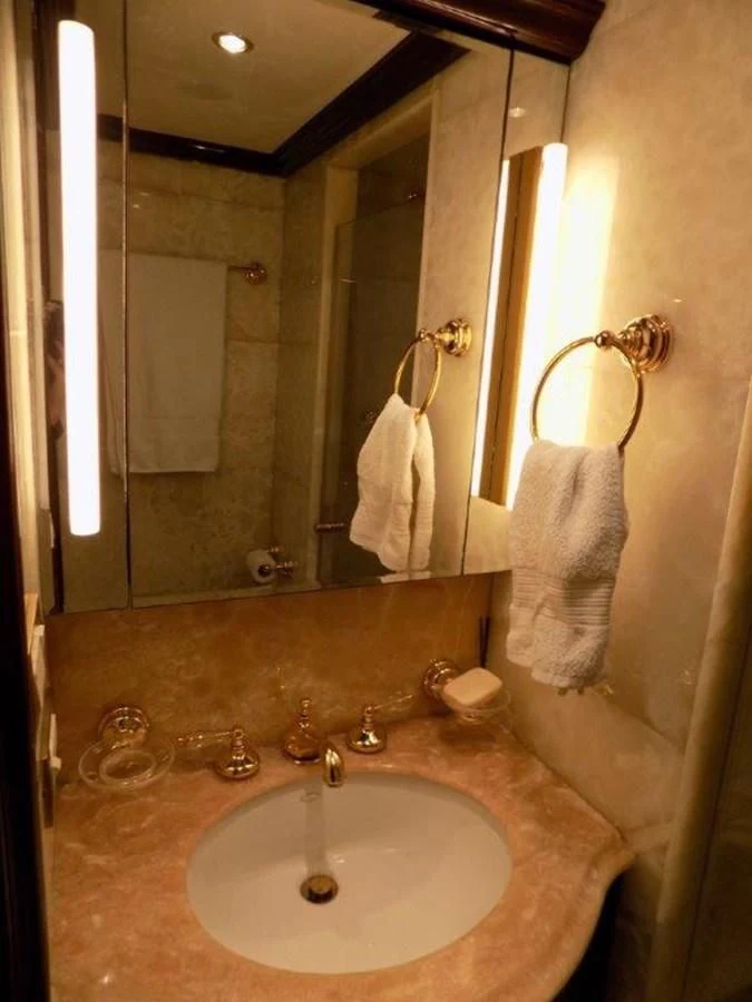 a bathroom with a sink and mirror aboard BENDIS Yacht for Sale