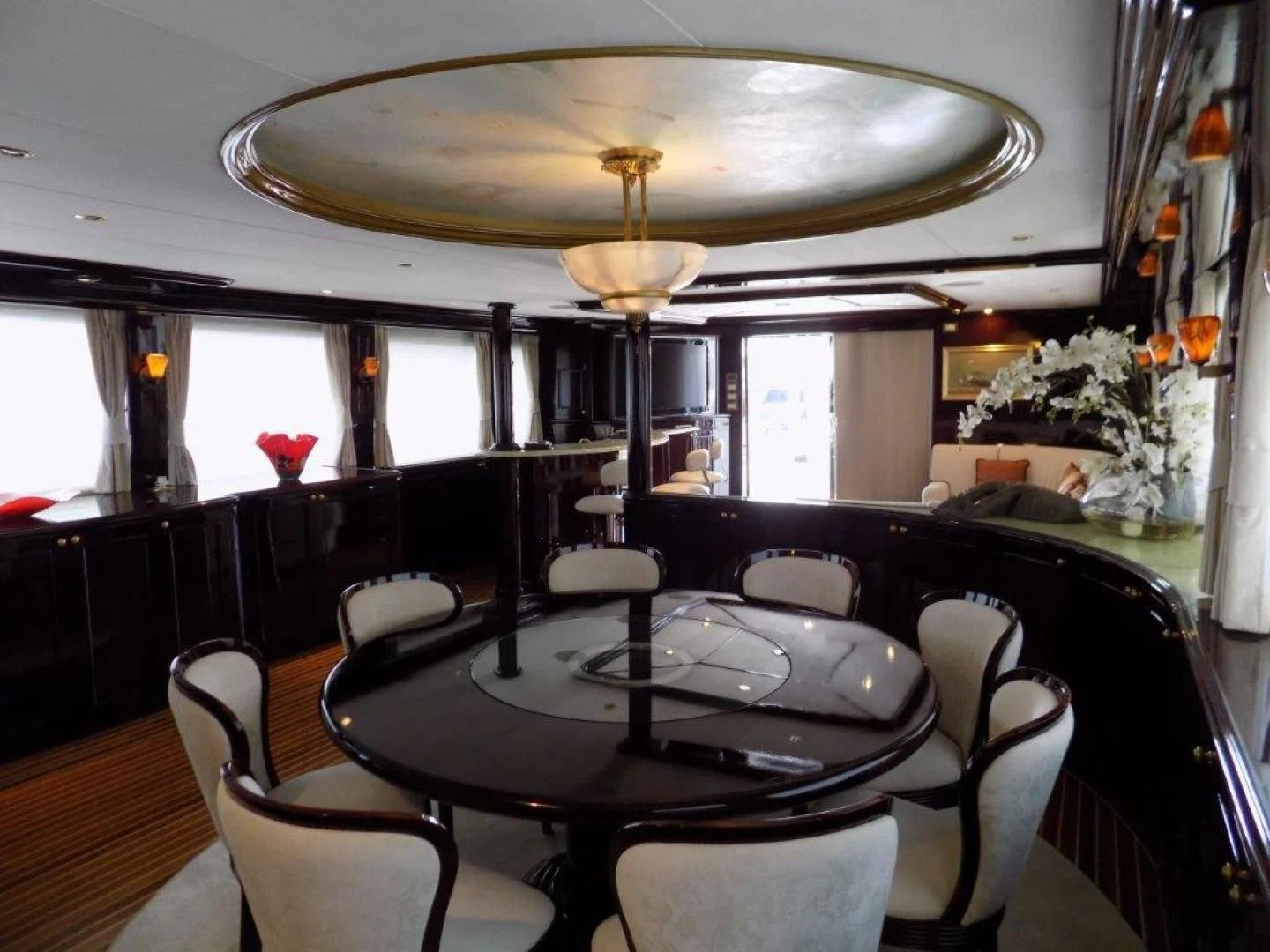 a dining room with a chandelier above it aboard BENDIS Yacht for Sale