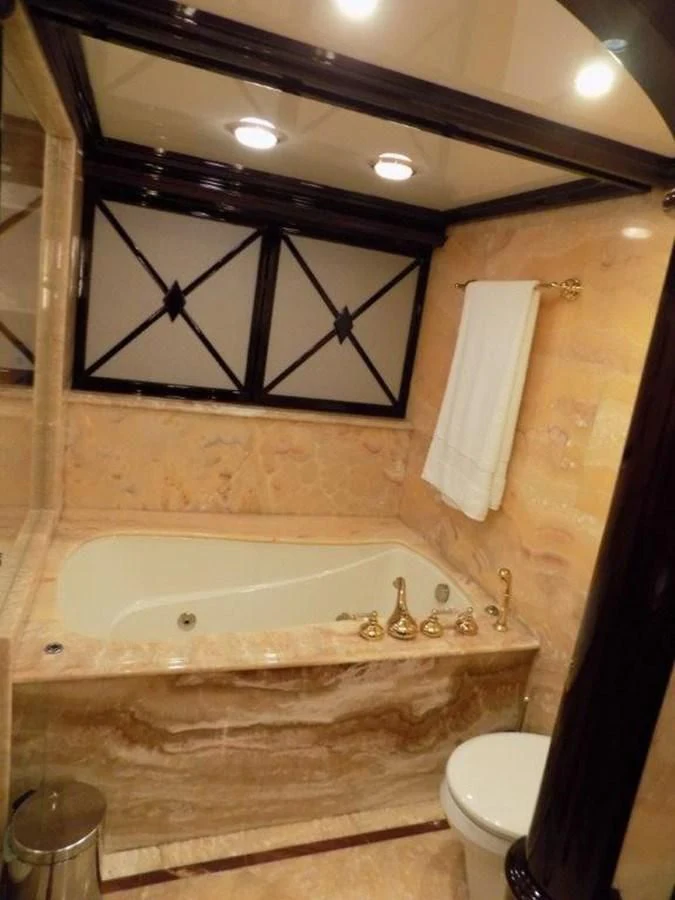 a bathroom with a tub and toilet aboard BENDIS Yacht for Sale