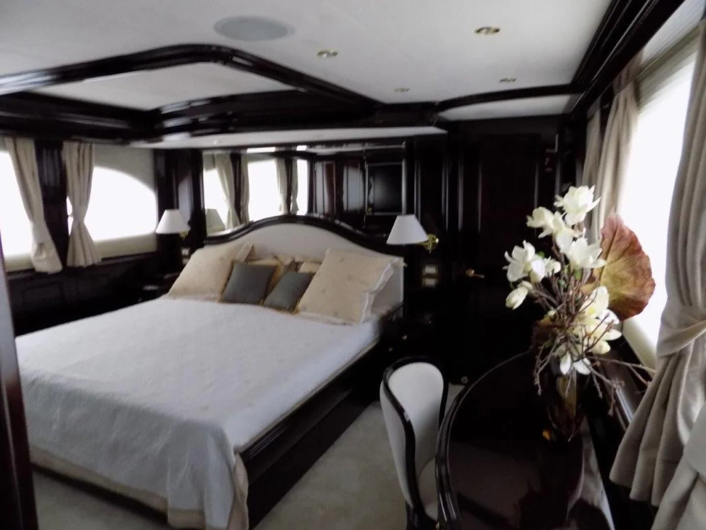 a bed with white sheets and pillows aboard BENDIS Yacht for Sale