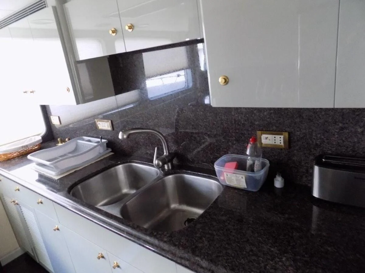 a kitchen with a sink and a microwave aboard BENDIS Yacht for Sale