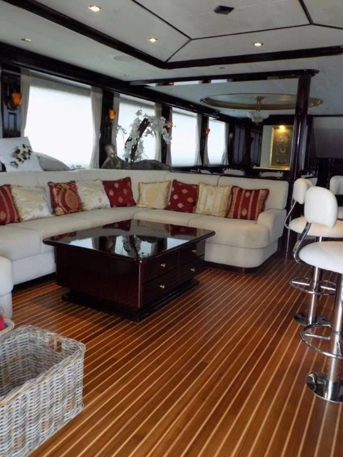 a living room with a couch and a coffee table aboard BENDIS Yacht for Sale