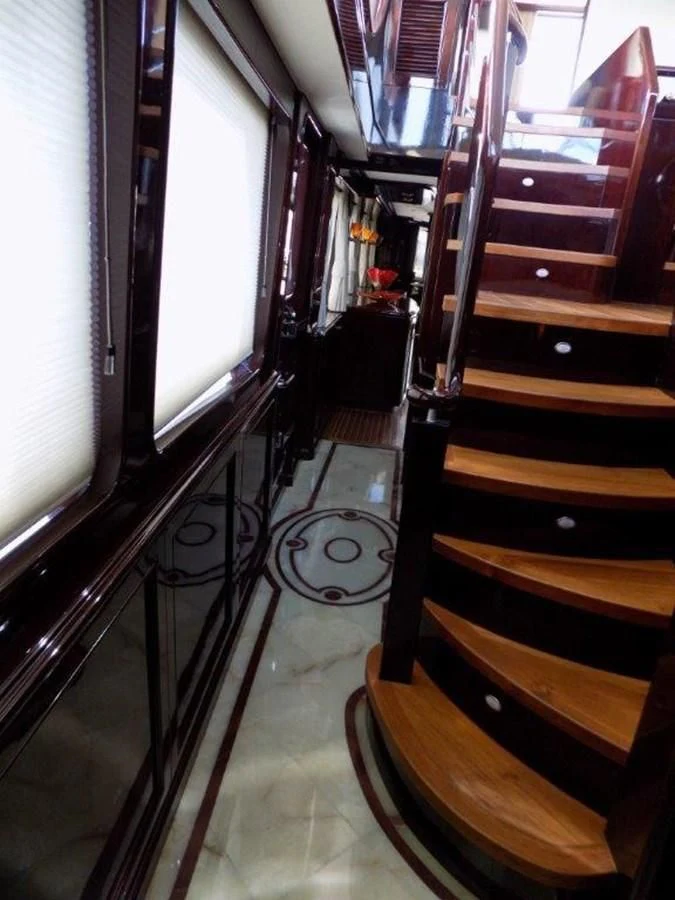 a room with a piano and a wood floor aboard BENDIS Yacht for Sale