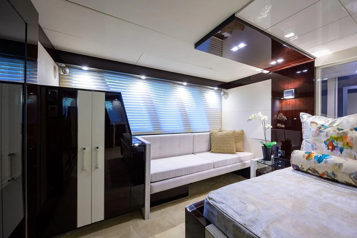 a bedroom with a bed and a couch aboard LADY NADIA Yacht for Sale