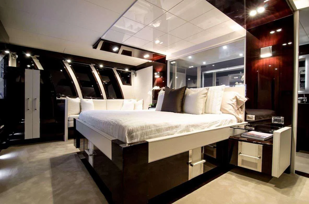 a room with a bed and desk aboard LADY NADIA Yacht for Sale