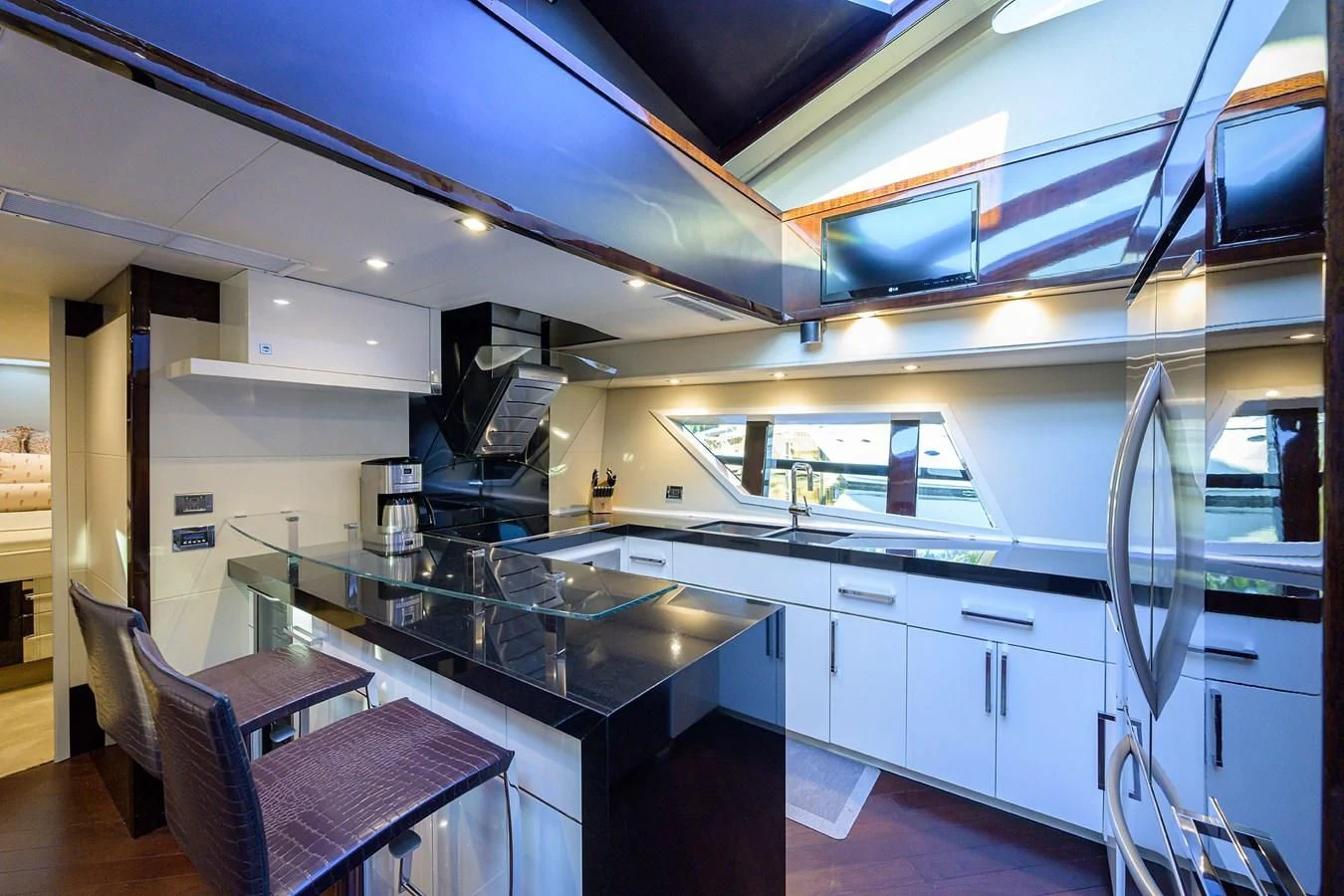 a kitchen with a bar and a table aboard LADY NADIA Yacht for Sale