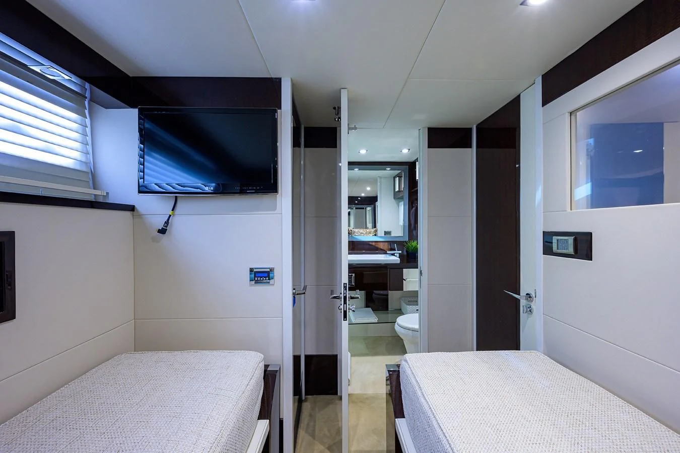 a room with a bed and a tv on the wall aboard LADY NADIA Yacht for Sale