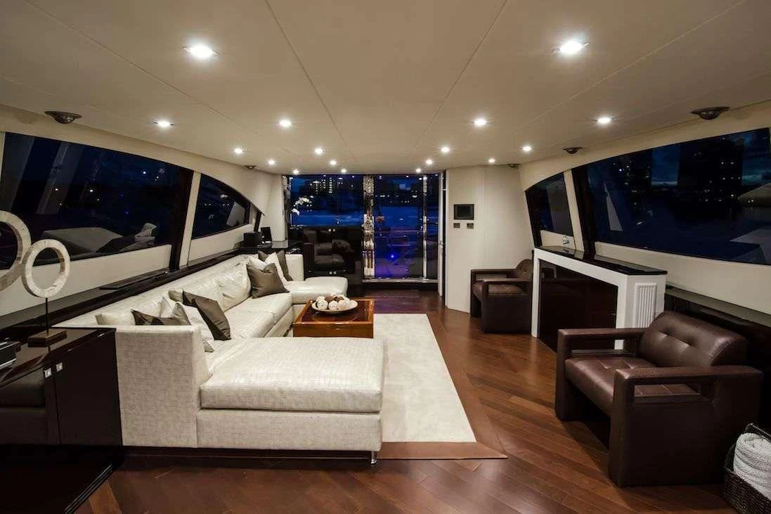 a living room with a large screen aboard LADY NADIA Yacht for Sale