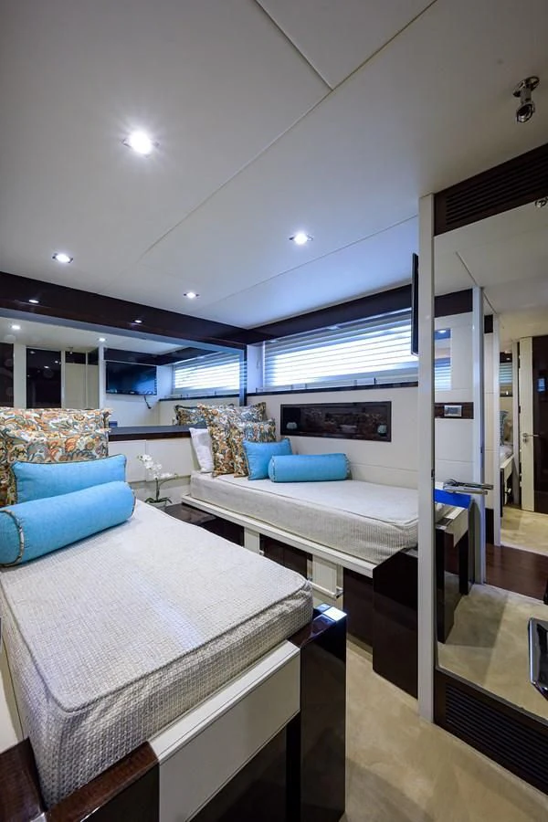 a bedroom with a bed and a large mirror aboard LADY NADIA Yacht for Sale
