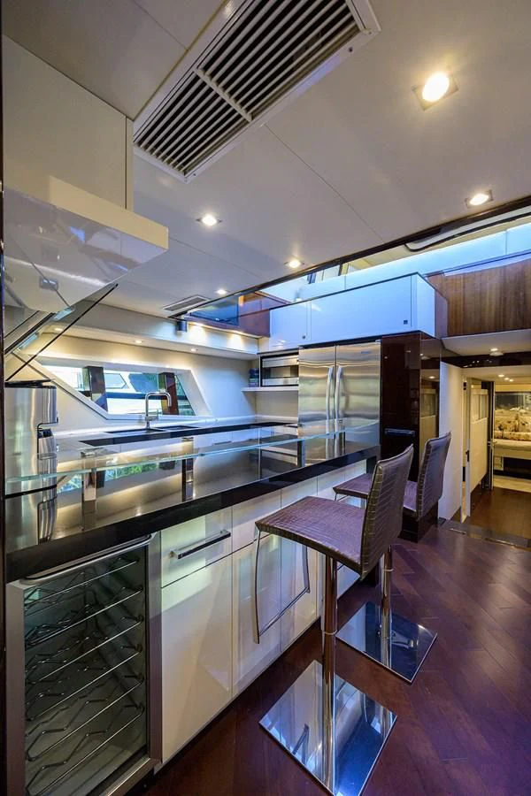 a kitchen with a bar and a table aboard LADY NADIA Yacht for Sale