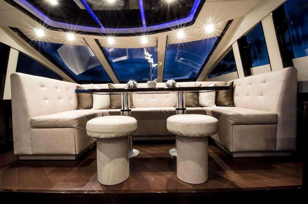 a room with a couple of couches and a large window aboard LADY NADIA Yacht for Sale