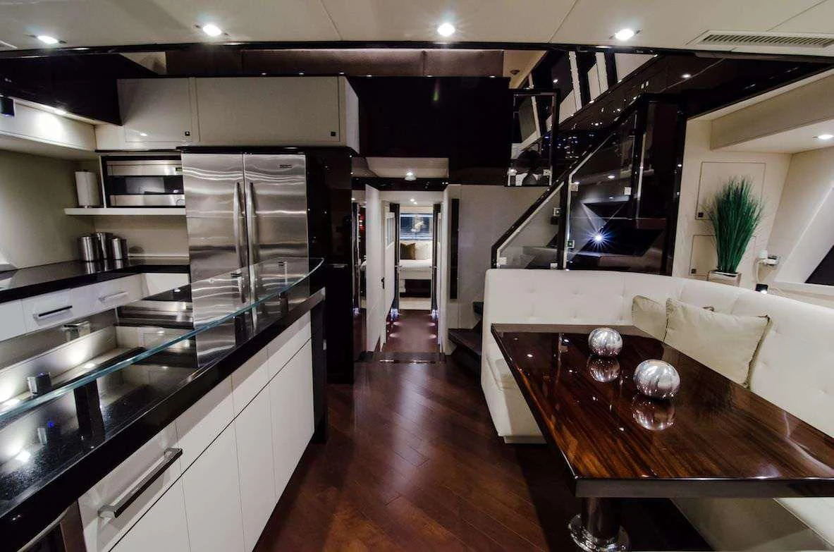 a kitchen with a table and a refrigerator aboard LADY NADIA Yacht for Sale