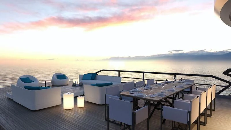 a deck with a table and chairs on it aboard PROJECT ALUNA 87 Yacht for Sale
