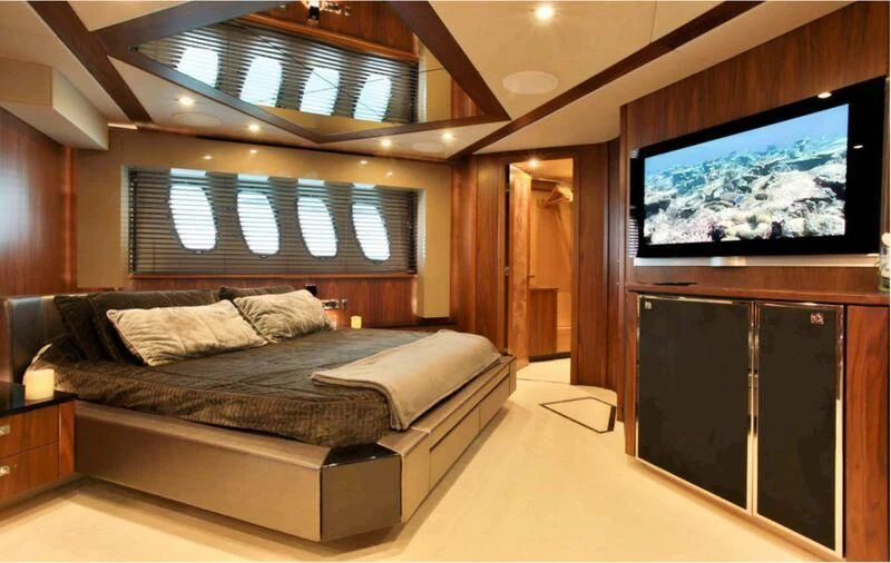 a room with a bed and a tv aboard JAX OF IBIZA Yacht for Sale