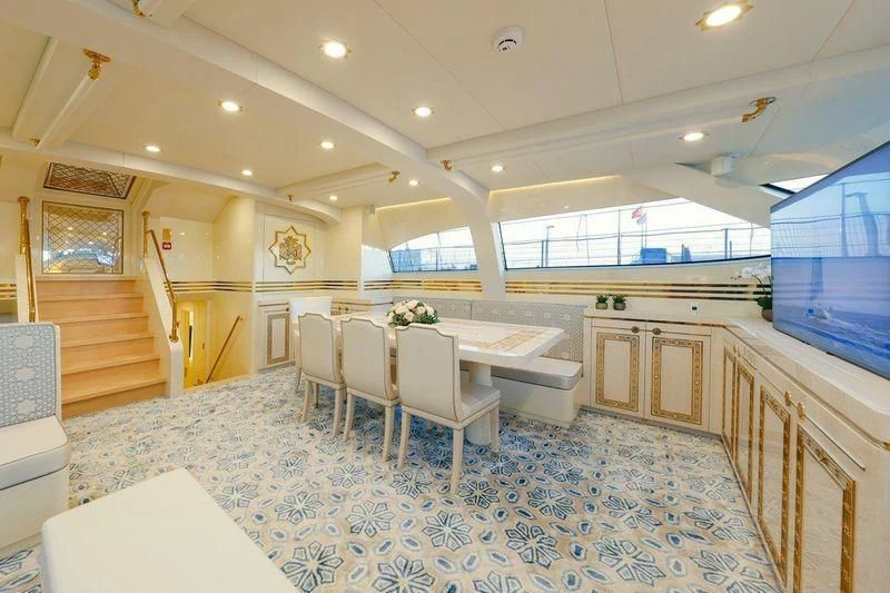 a large room with a table and chairs aboard RUHUBELENT Yacht for Sale