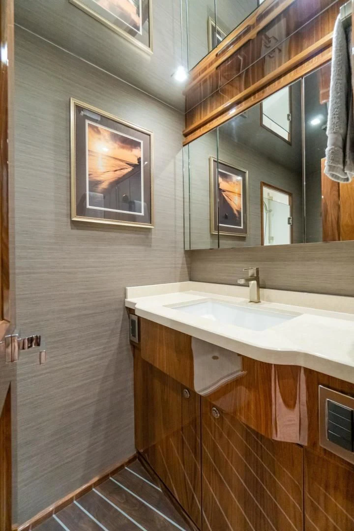 a bathroom with a sink and mirror aboard TAG TEAM Yacht for Sale
