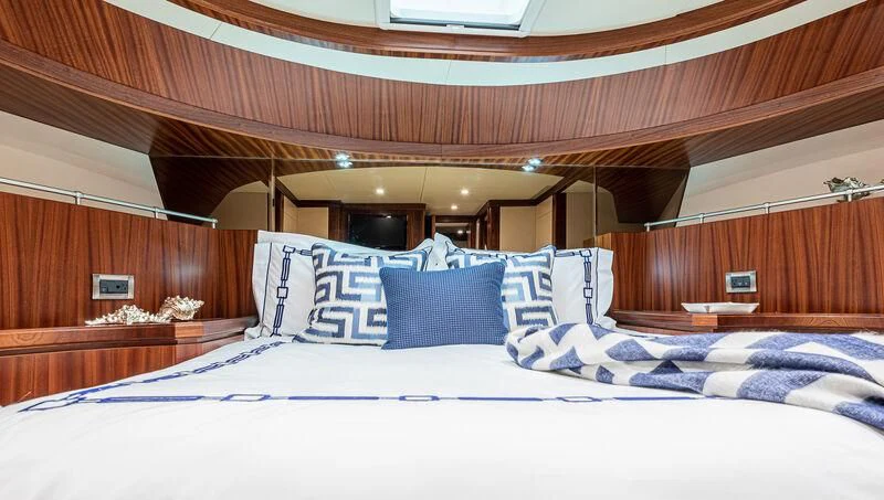 a bed with blue and white sheets aboard RHYTHM'N BLUES Yacht for Sale