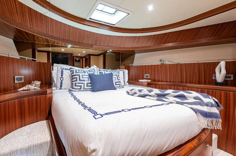 a bed with blue and white sheets aboard RHYTHM'N BLUES Yacht for Sale