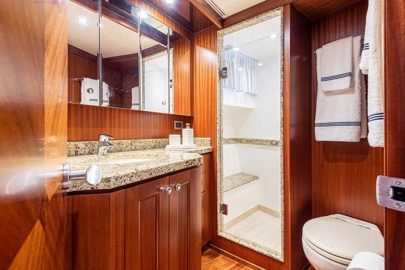 a bathroom with a glass shower door aboard RHYTHM'N BLUES Yacht for Sale