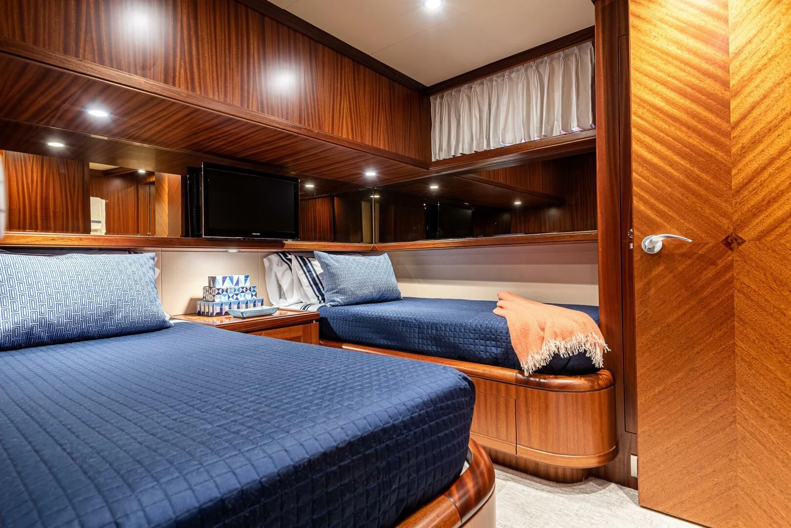 a room with a bed and a television aboard RHYTHM'N BLUES Yacht for Sale