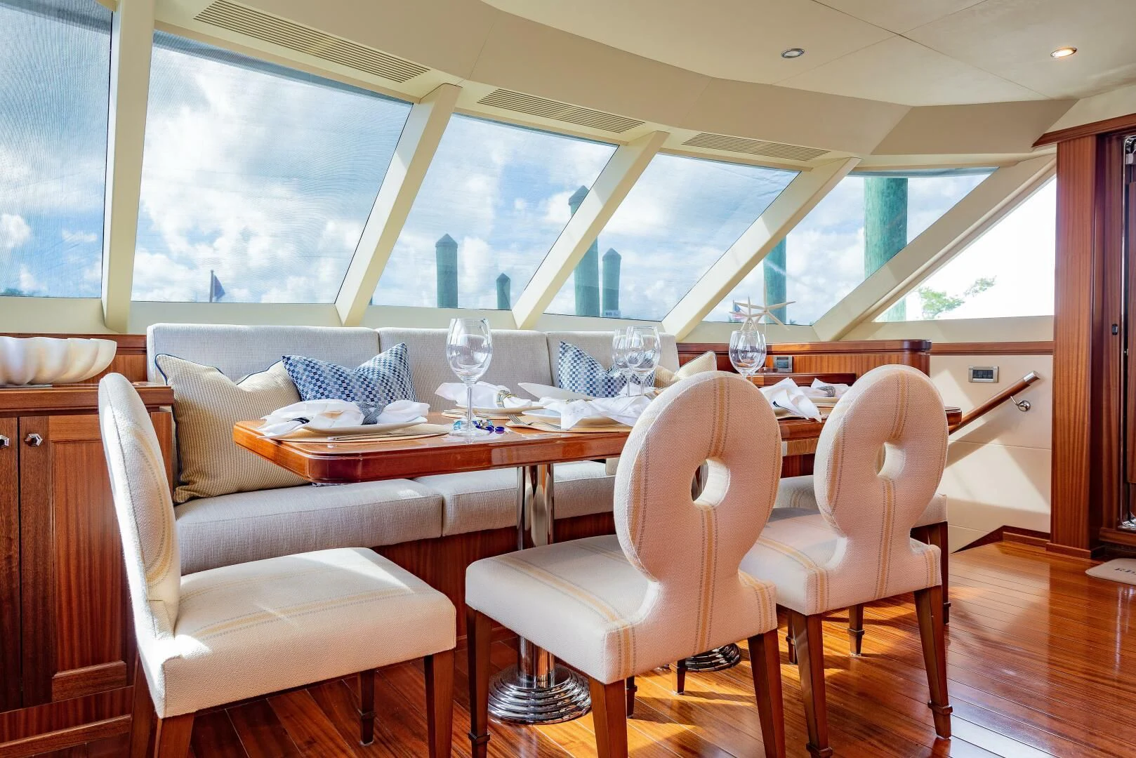 a dining table with chairs and a view of the city aboard RHYTHM'N BLUES Yacht for Sale