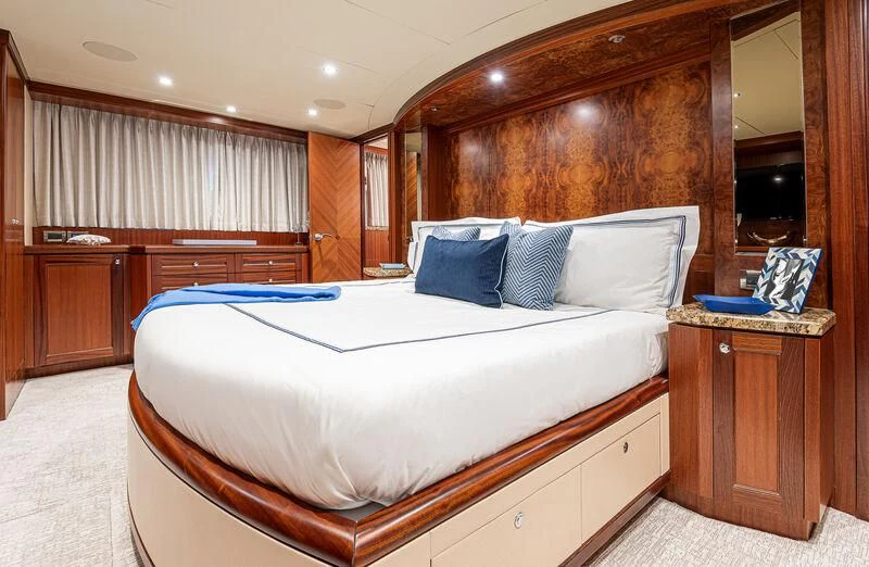 a bed with a white sheet and blue pillows aboard RHYTHM'N BLUES Yacht for Sale