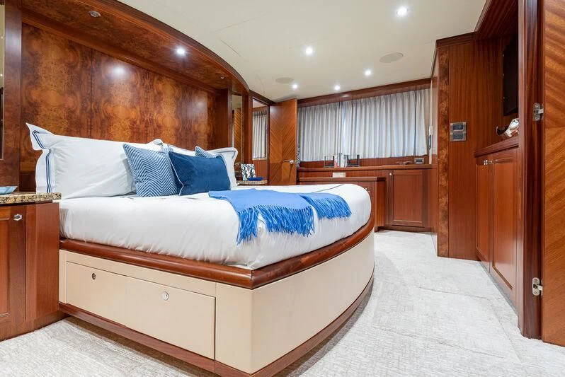 a bedroom with a bed and a closet aboard RHYTHM'N BLUES Yacht for Sale