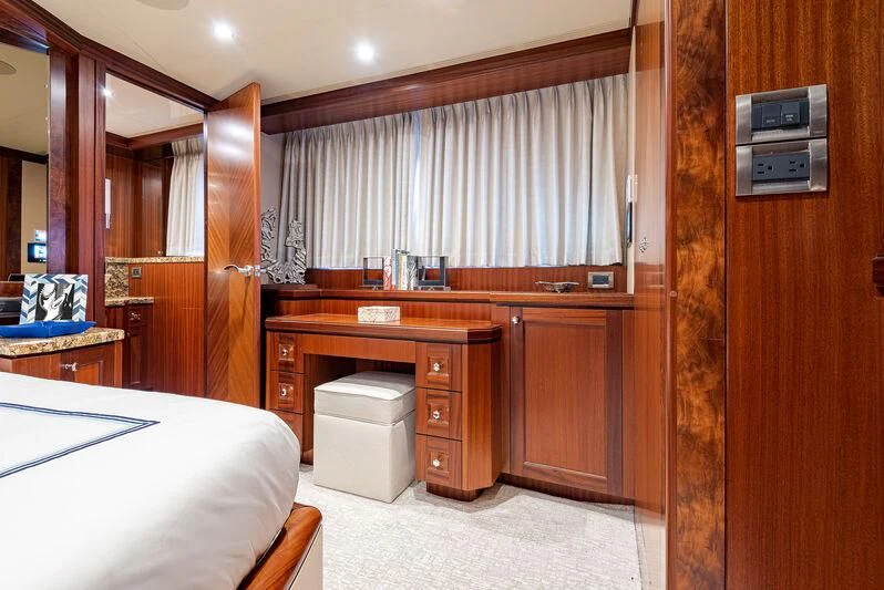 a bedroom with a bed and a desk aboard RHYTHM'N BLUES Yacht for Sale
