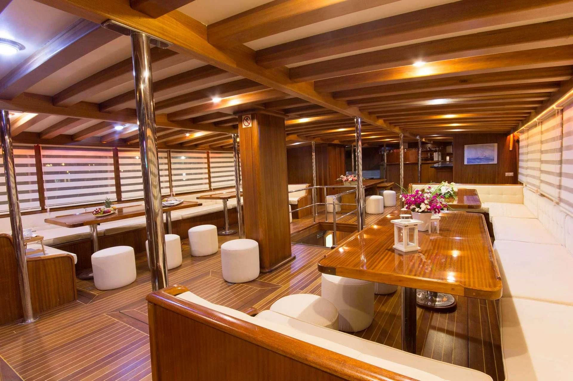 a room with tables and chairs aboard ATHENA Yacht for Sale