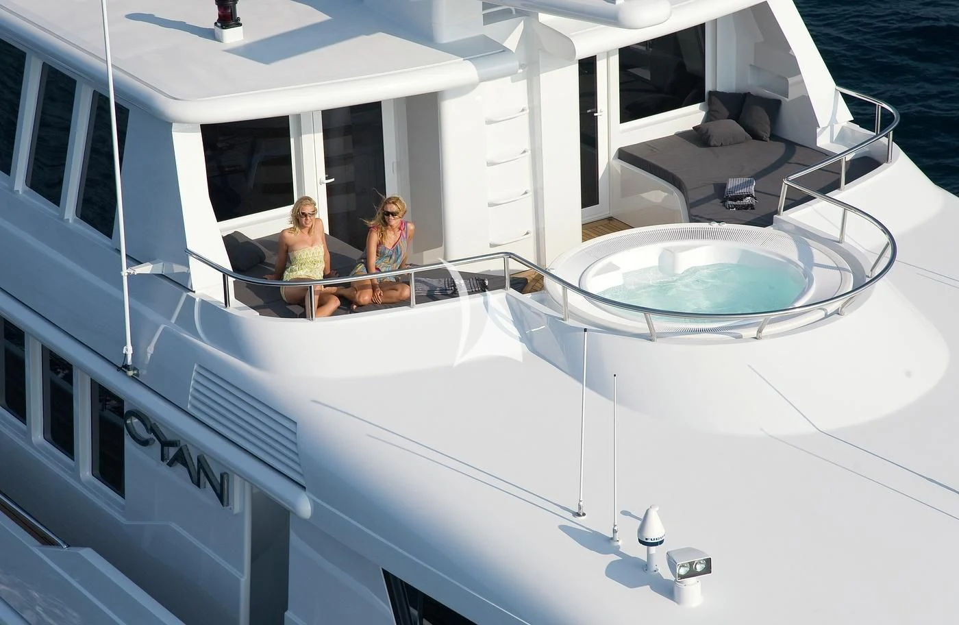 a group of people sitting on a white yacht aboard CYAN Yacht for Sale