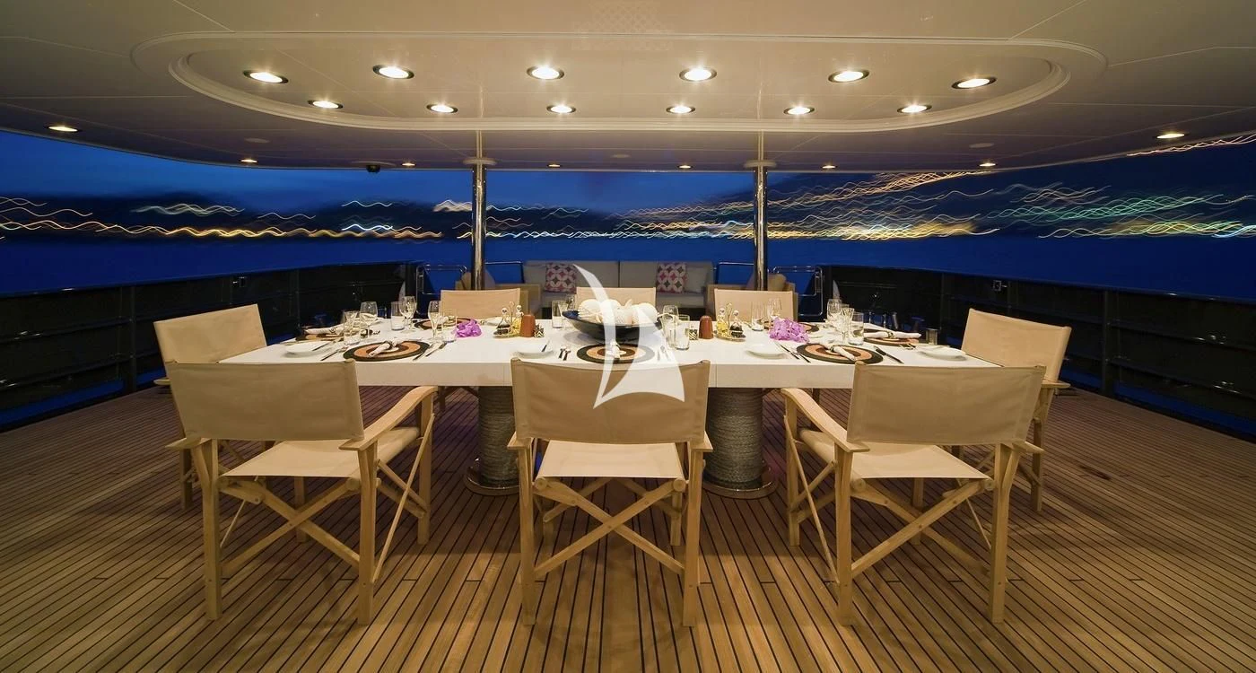 a room with chairs and tables aboard CYAN Yacht for Sale