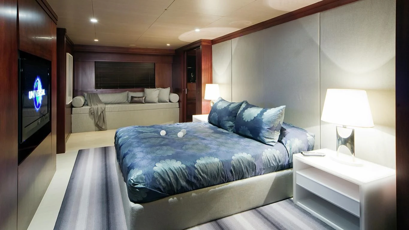 a bedroom with a bed and a television aboard CYAN Yacht for Sale