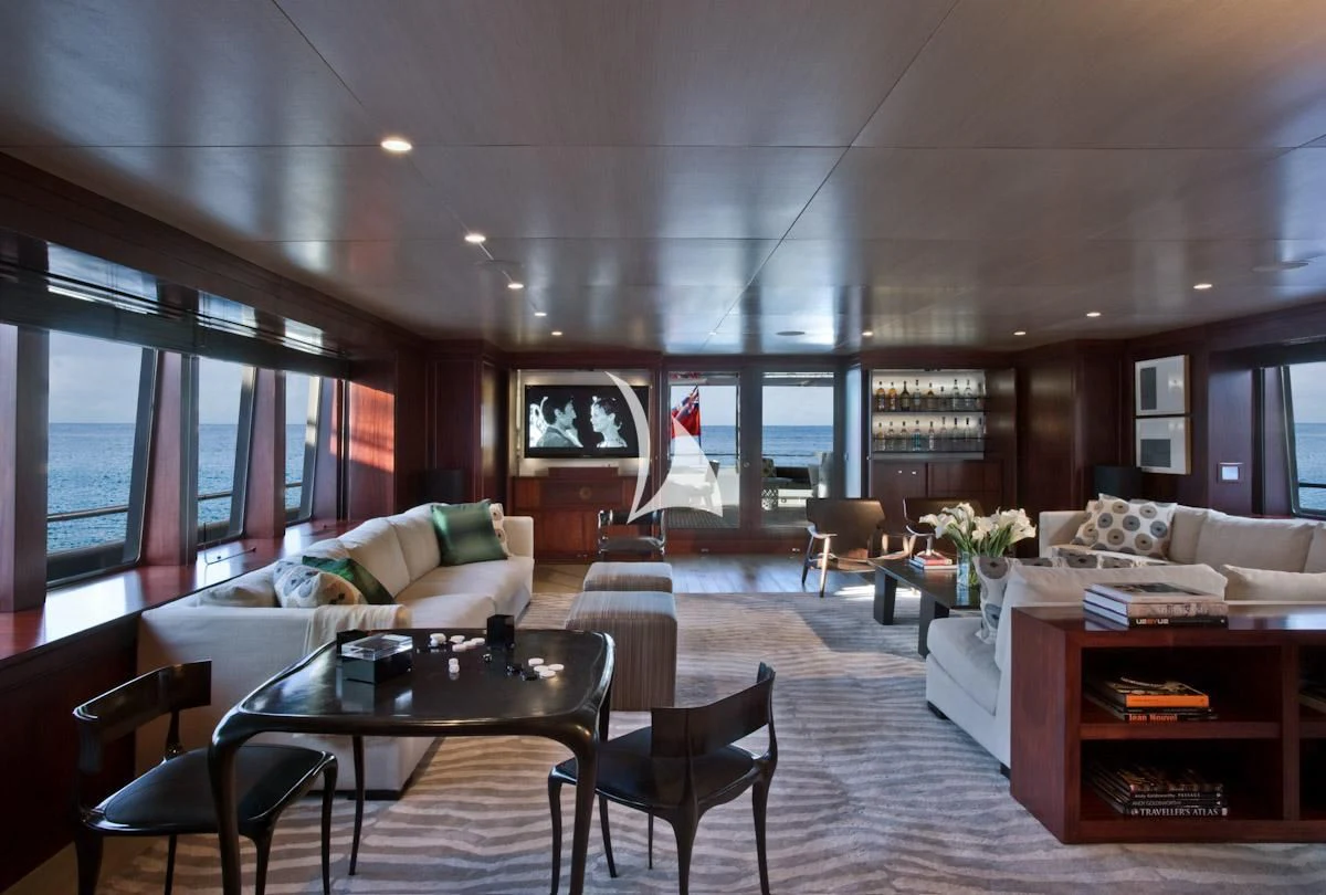 a living room with a table and chairs aboard CYAN Yacht for Sale