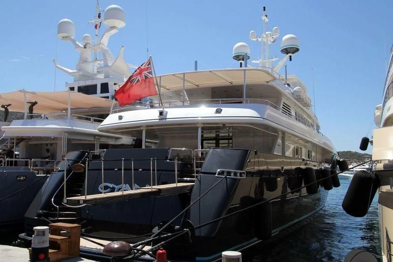 a boat with a flag on the front aboard CYAN Yacht for Sale