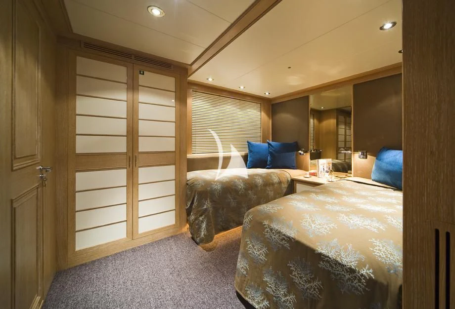 a room with a bed and a couch aboard CYAN Yacht for Sale