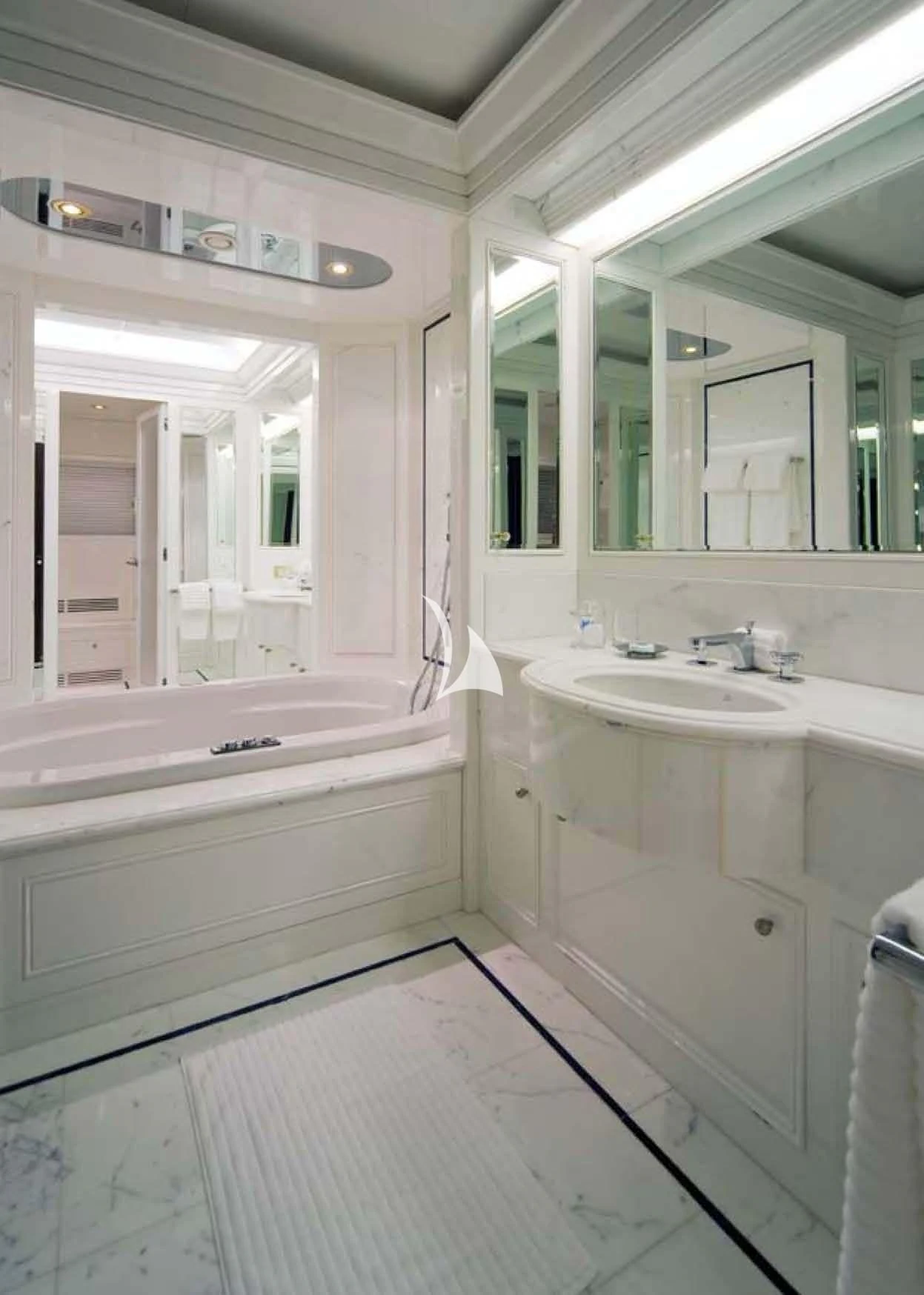 a bathroom with a tub sink and a sink aboard CYAN Yacht for Sale